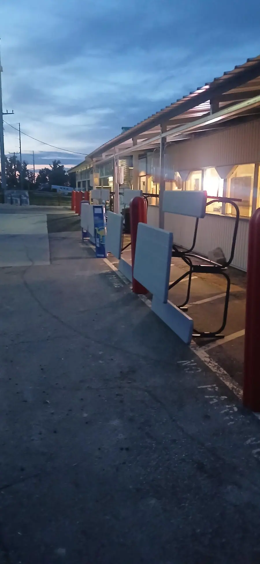 A covered storefront walkway at dusk