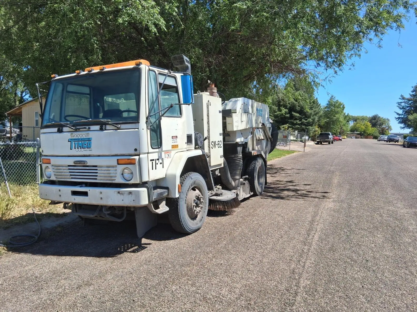 Sweep-A-Lot TYMCO street sweeper parked on a residential street